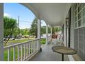 Inviting front porch with white columns, railings, and a seating area at 34 Duke Dr, Lawrenceville, GA 30046