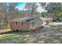 A well-maintained brick home is shown with a manicured lawn at 574 Oak Grove Rd, Temple, GA 30179