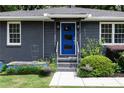 Close-up of a home's entrance, highlighting a vibrant blue door with modern design at 957 Sharon Se Cir, Smyrna, GA 30080
