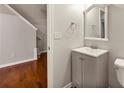 Cozy half bath with grey vanity, wood floors, and neutral walls at 2060 Ellison Nw Way # 11, Kennesaw, GA 30152
