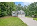 Well-maintained home with two-car garage and a spacious driveway, nestled in a lush green setting at 2326 Westland Way, Acworth, GA 30102