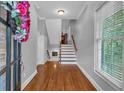 Bright foyer with hardwood floors, staircase, and fresh neutral paint at 5407 Waters Edge Trl, Roswell, GA 30075