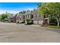 A row of well-maintained brick townhomes in a quiet neighborhood at 5407 Waters Edge Trl, Roswell, GA 30075