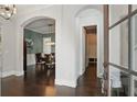 Elegant entryway featuring hardwood floors, arched doorways, and views into the dining area and hallway at 1811 Kent Ave, Dunwoody, GA 30338