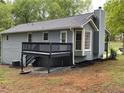 View of the home's rear exterior featuring a deck and bay window at 214 Sweetwater Cir, Powder Springs, GA 30127