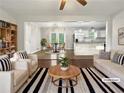 Bright, airy living room with hardwood floors, white sofas, and open floor plan at 3653 Mecklinburg Pl, Decatur, GA 30032