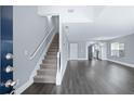 Inviting entryway boasts hardwood floors and staircase leading to the upper level of the home at 577 Cypher Dr, Suwanee, GA 30024