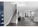 Inviting living room boasts hardwood floors and staircase leading to the upper level of the home at 577 Cypher Dr, Suwanee, GA 30024