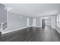 Open-concept living room features hardwood floors and seamlessly connects to the kitchen area at 577 Cypher Dr, Suwanee, GA 30024