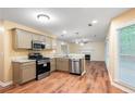 Spacious kitchen with stainless steel appliances, granite countertops, and hardwood floors at 6939 Waters Edge Dr, Stone Mountain, GA 30087