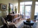 Bright living space with large windows, a balcony access, and refined furniture arrangements at 711 Cosmopolitan Ne Dr # 123, Atlanta, GA 30324