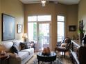 Living room with natural light, comfortable seating, and access to outdoor balcony at 711 Cosmopolitan Ne Dr # 123, Atlanta, GA 30324