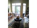 Living room with large windows, balcony access and a comfortable seating arrangement at 711 Cosmopolitan Ne Dr # 123, Atlanta, GA 30324