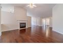 Open-concept living room featuring hardwood floors, fireplace, and easy access to entry at 1022 Pecan Grove Pl, Lawrenceville, GA 30046