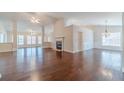 Spacious living room with hardwood floors, fireplace, and plenty of natural light at 1022 Pecan Grove Pl, Lawrenceville, GA 30046