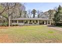 Attractive single-story home featuring a covered carport and beautiful landscaping at 1598 Kings Rd, Marietta, GA 30062