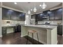 Modern kitchen featuring dark wood cabinets, granite countertops, and stainless steel appliances at 207 Cherokee Reserve Cir, Canton, GA 30115