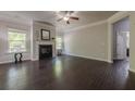 Spacious living room with hardwood floors, fireplace, and natural light from large windows at 207 Cherokee Reserve Cir, Canton, GA 30115