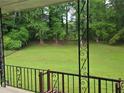 View from the porch overlooking a lush, green backyard with mature trees creating a private oasis at 2555 Angus Sw Ct, Marietta, GA 30008