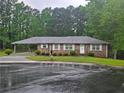 Charming one-story brick home with a covered carport and a well-manicured front lawn at 2555 Angus Sw Ct, Marietta, GA 30008