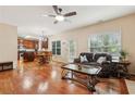 Open-concept living room and eat-in kitchen offers wood floors and an abundance of natural light at 4560 Weathervane Dr, Alpharetta, GA 30022