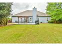 Spacious backyard with a patio and pergola, perfect for outdoor entertaining at 1719 Kings Cross Ct, Hoschton, GA 30548