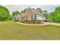 Well-maintained home exterior with manicured lawn and attached garage at 1719 Kings Cross Ct, Hoschton, GA 30548