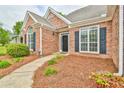 Inviting front entrance with brick facade and manicured landscaping at 1719 Kings Cross Ct, Hoschton, GA 30548