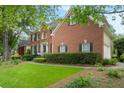 Well-kept brick home featuring manicured landscaping and an expansive green lawn at 400 Fieldstone Lndg, Alpharetta, GA 30005