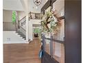 Inviting foyer with hardwood floors, a staircase, and a view into the living room. Natural light shining from the foyer at 6615 Callanwalde Ct, Suwanee, GA 30024