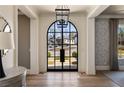 Elegant foyer with a soaring arched doorway and view of the front lawn and driveway at 810 Kenry Ct, Atlanta, GA 30342
