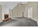 Spacious living room with a brick fireplace, high ceilings, and neutral carpeting at 3425 Sweet Basil Ln, Loganville, GA 30052