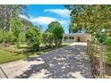 Exterior shot of a home with a long driveway leading up to the carport at 3951 Lindley Dr, Powder Springs, GA 30127