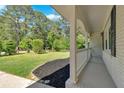 Charming front porch with stylish white pillars and black mulch landscaping at 3951 Lindley Dr, Powder Springs, GA 30127