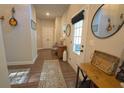 Inviting hallway with wood flooring, decorative accents, and a clear view to the door at 453 Mulberry Rock Rd Rd, Temple, GA 30179