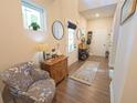 Inviting hallway with wood flooring, a chair with floral pattern, and a view to the outside at 453 Mulberry Rock Rd Rd, Temple, GA 30179