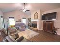 Bright living room features a cozy fireplace, plush seating, and natural light, creating an inviting atmosphere at 453 Mulberry Rock Rd Rd, Temple, GA 30179
