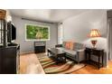 Bright living room featuring a large window with scenic outdoor views and stylish decor at 148 Waverly Way # 10, Atlanta, GA 30307