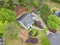 Aerial view of the home showcasing a well-maintained yard and mature trees surrounding the property at 1633 Clifton Downs Ct, Kennesaw, GA 30144