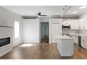 Open-concept living area with modern fireplace and island-style kitchen at 3087 Semmes St, Atlanta, GA 30344