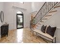 Grand foyer showcasing decorative tile flooring and a staircase with ornate iron railing at 8345 Jett Ferry Rd, Sandy Springs, GA 30350