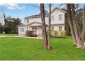 Two-story home framed by mature trees, featuring a well-kept lawn, an inviting porch, and a mix of painted brick and siding at 2206 Loring Ct, Decatur, GA 30032