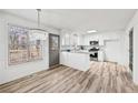 Bright kitchen with white cabinets, stainless steel appliances, granite countertops, and wood-look floors at 3362 Alexis Ct, Marietta, GA 30066