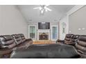 Inviting living room showcasing a fireplace and comfortable leather furniture, perfect for relaxation at 20 Madison Ct, Covington, GA 30016
