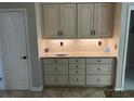 Convenient butler's pantry offers extra storage and counter space with designer cabinetry at 2435 Jakin Way, Suwanee, GA 30024