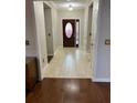 Inviting entryway featuring decorative front door, tile flooring, and crown molding at 2435 Jakin Way, Suwanee, GA 30024