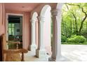 Inviting porch with classic white columns, a wooden bench, and views of the verdant yard at 4705 Paran Nw Vly, Atlanta, GA 30327
