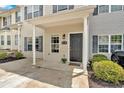 Welcoming front entrance with a gray door, neutral siding, and manicured landscaping at 261 Venture Path, Hiram, GA 30141