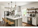 Bright kitchen featuring a large island with seating, pendant lights, and stainless steel appliances at 331 Gordon Ne Ave, Atlanta, GA 30307