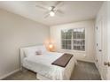 Cozy bedroom with carpet, a ceiling fan, and a window offering natural light at 332 Red Fox Dr, Canton, GA 30114